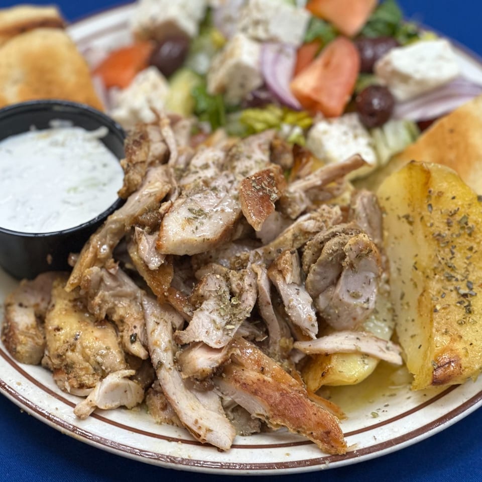 Opa Greek Restaurant's chicken gyro plate with tzatziki, pita, roasted potatoes, and Greek salad.