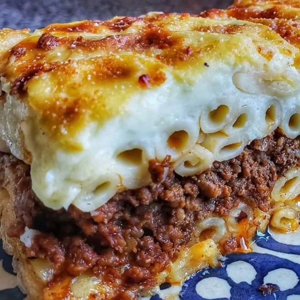 Close-up of a delicious pastitsio with layers of pasta, ground meat, and creamy béchamel sauce.