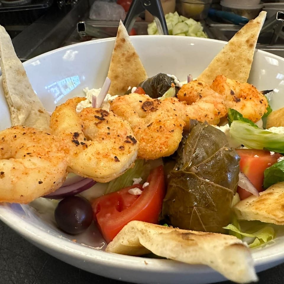 Opa Greek Restaurant's shrimp salad with pita, dolmades, tomatoes, olives, and feta cheese.