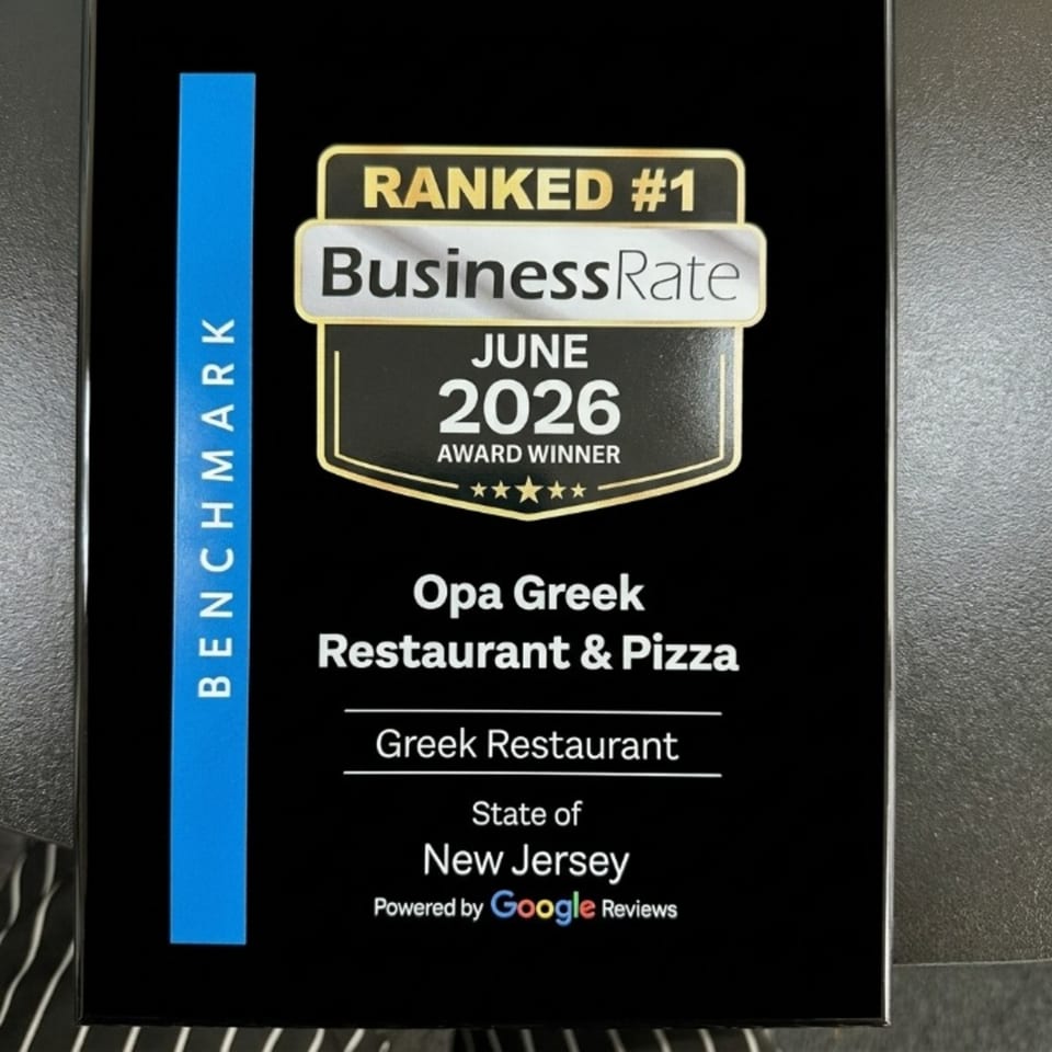 A black plaque with gold and white text, announcing Opa Greek Restaurant & Pizza as a #1 BusinessRate award winner.